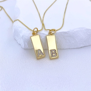 Elegant gold necklaces with rectangular zircon A and B letter pendants on white stone