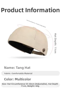 Detail view of cotton docker cap with metal maple leaf badge and adjustable strap
