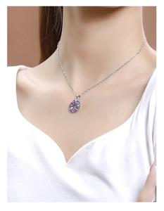 Close-up of 925 sterling silver necklace with purple zircon flower pendant on model