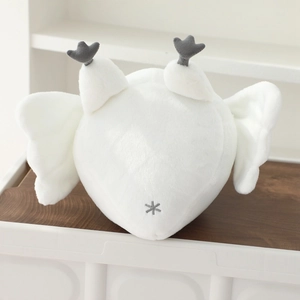 Detailed view of white heart-shaped plush with soft texture and star embroidery detail