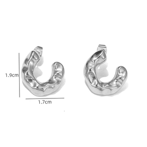 Detail of silver geometric earrings with hammered texture and 1.9cm height specifications