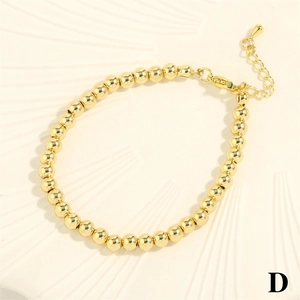 Detail of gold beaded bracelet featuring a secure lobster clasp and adjustable extension chain