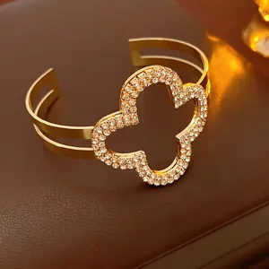 Luxury gold-plated open clover bracelet with sparkling cubic zirconia pavé detailing