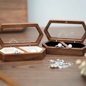 Detail of wooden hexagonal jewelry box with walnut grain and clear window lids
