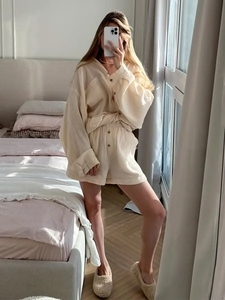 Detail of beige double gauze texture fabric on long sleeve shirt and matching shorts