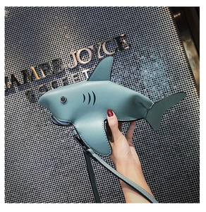 Detail shot of blue PU leather shark-shaped mini crossbody bag with zip mouth and fins