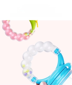 Detail of baby rattle teether with colorful internal rolling beads and textured tubes