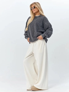 Detail showing oversized washed gray sweatshirt paired with high-waist drawstring wide-leg pants