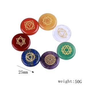 Detailed top view of 7 chakra healing crystal set with engraved golden symbols on stones