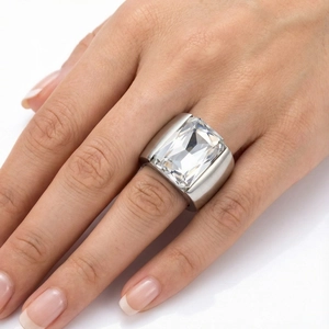 Macro detail of silver titanium steel ring featuring a large rectangular zircon on model's hand