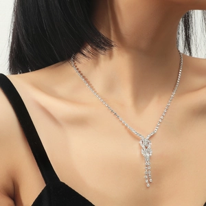 Silver bridal necklace set with sparkling crystal knot design and elegant fringe tassels