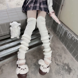 Detailed texture of white ribbed knit leg warmers in a slouchy JK style fashion