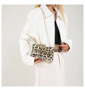 Close-up of leopard print evening bag featuring a gold chain and diamond-encrusted clasp