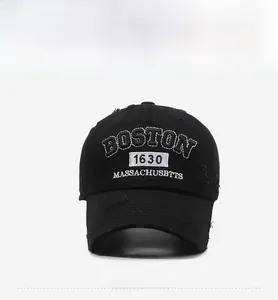 Macro shot of vintage black cotton baseball cap with white Boston 1630 embroidery details