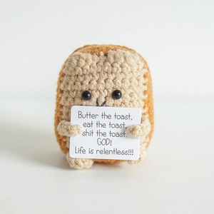 Handmade crochet toast doll holding a funny positive card for desk decor and stress relief