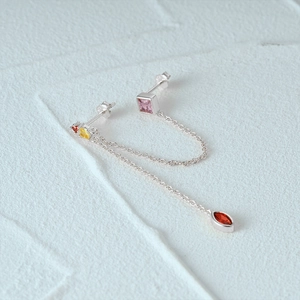 Detail of S925 silver fringe earrings with multi-colored gemstones and long chains