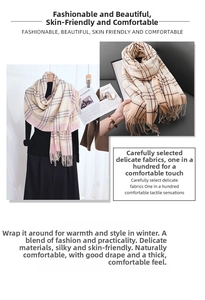Detail of soft plaid scarf with tassels in beige and pink autumn winter fashion style