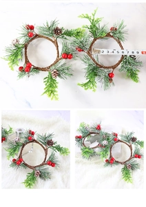 Detail of Christmas candle ring with red berries, pine needles, and pinecone measuring 4.5cm