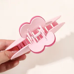 Detail of pink butterfly hair claw clip with double-layer design and metal spring