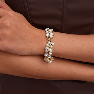 Detailed close-up of Baroque gold necklace with white pearls and sparkling rhinestones