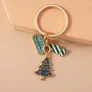 Close-up of Christmas keychain with enamel candy cane and merry christmas tag detail