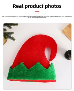 Detail of red and green Christmas elf hat with golden bells and holiday pine decor