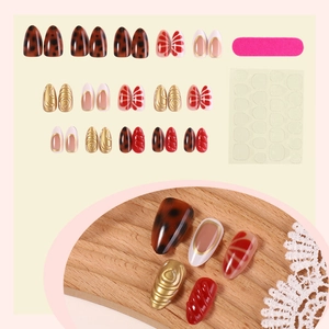 Short almond press-on nail kit with leopard print and 3D gold accents and glue