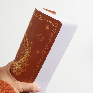 Brown faux leather undated English weekly planner with gold foil starburst face design