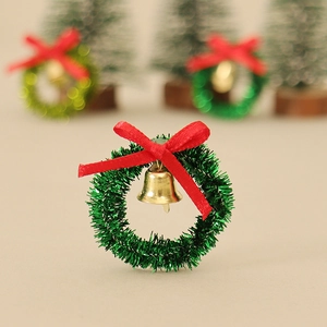 Miniature Christmas wreath with red bow and gold bell for festive DIY crafts