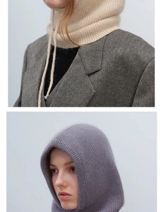 Detail of knitted balaclava hood showing beige and grey fabric texture and drawstring