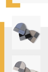 Macro detail of the color-block ribbed knit wool beanie with thick texture and cuffed hem