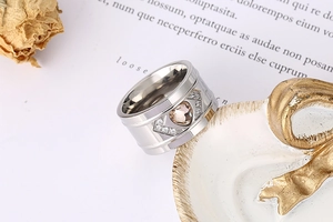 Macro detail of wide silver ring with champagne heart gem on vintage book pages