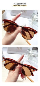 Close-up of retro clubmaster sunglasses with tea-colored lenses and golden metal frames