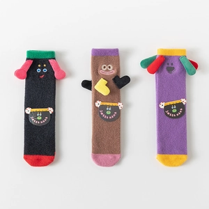 Detailed view of three pairs of coral fleece socks with 3D cartoon animal decorations