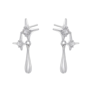 Close-up of silver star stud earrings with teardrop metal pendants and cubic zirconia