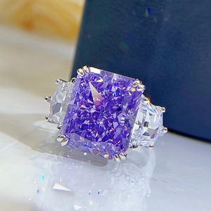 Macro view of luxury ring featuring a large purple radiant cut stone with side diamonds