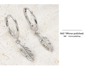Macro shot of 925 sterling silver feather earrings featuring 360-degree mirror polishing