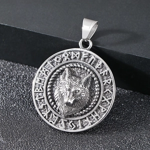 Macro shot of Viking wolf head pendant with Nordic runes and polished steel finish
