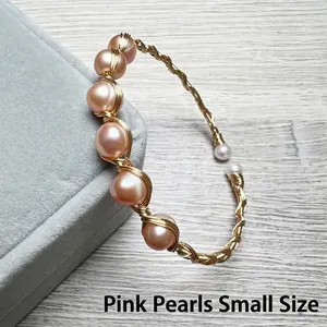 Detail of pink pearls on 14K gold filled wire wrapped handmade cuff bracelet