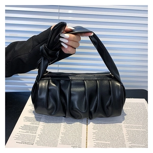 Detailed close-up of a black ruched cloud bag showing soft PU leather texture and knotted handle