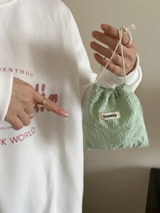 Light green drawstring pouch with 3D texture for makeup and jewelry organization