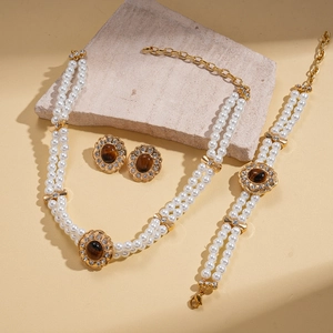 Detailed shot of double-row pearl jewelry set with tiger eye stones and rhinestones