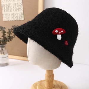 Detail of cute mushroom embroidery on black faux fur winter bucket hat for women