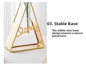Detail of stable gold metal tripod base and glass tube vase with Love script detail