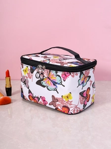 Floral butterfly makeup bag with dual zippers and handle on marble desk