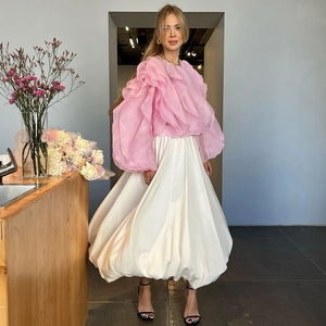 Detail van roze organza top met ruches en witte satijnen ballonrok textuur