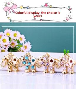 Detailed close-up of four colorful crystal elephant keychains with gold metal plating