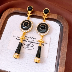 Detailed close-up of vintage French earrings with black stones and sparkling rhinestones