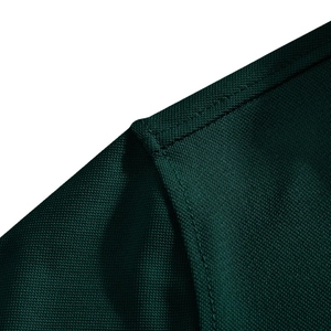 Close-up of dark green piqué polo shirt fabric texture with fine double stitching details