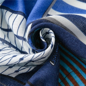 Detailed macro view of blue horse carriage pattern scarf showing fine fabric texture and weave